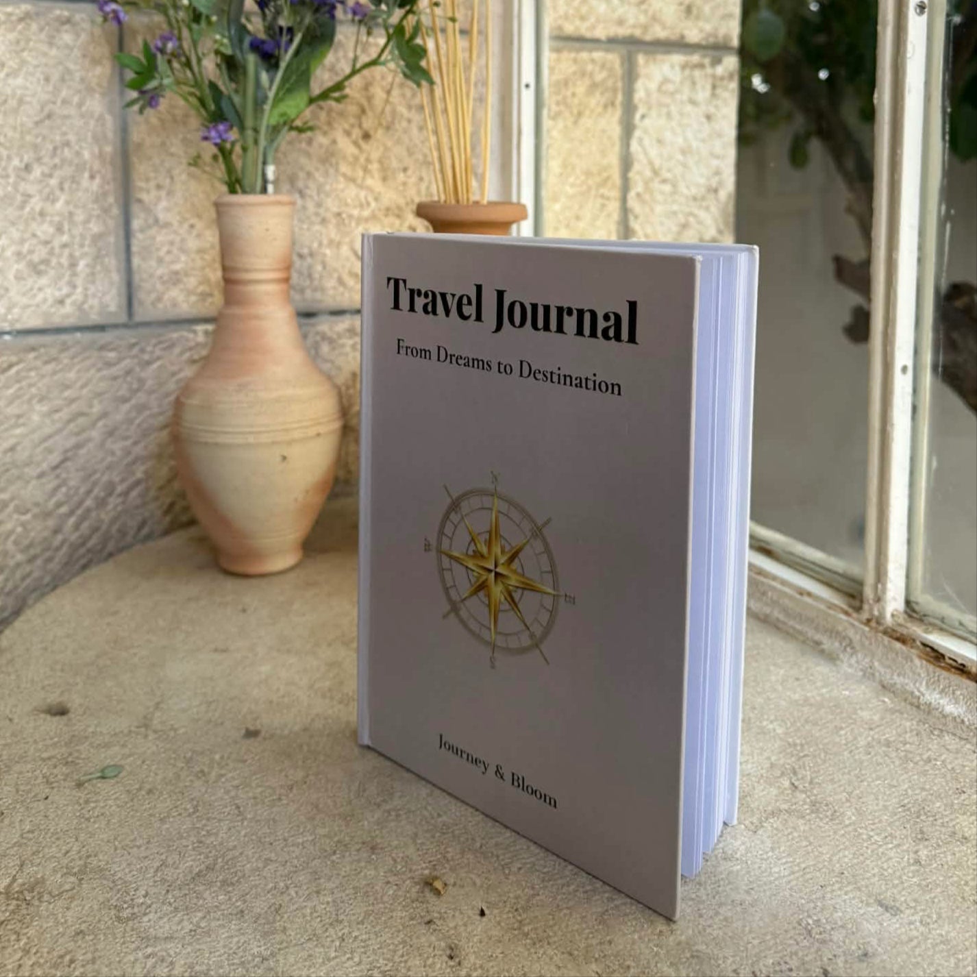 Travel Journal standing on a windowsill with sunlight — captured after a trip to Portugal.